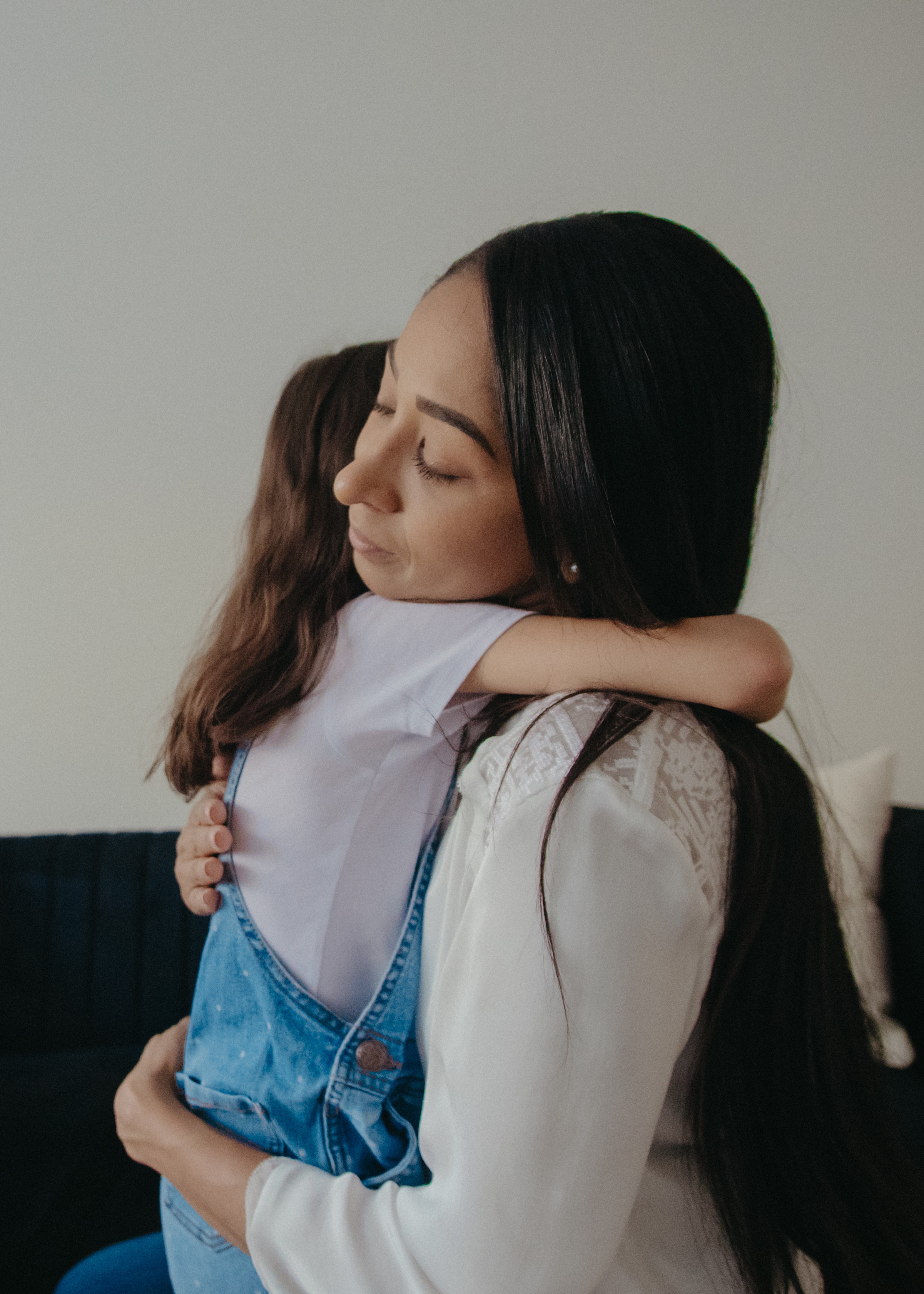 A mother hugs her daughter