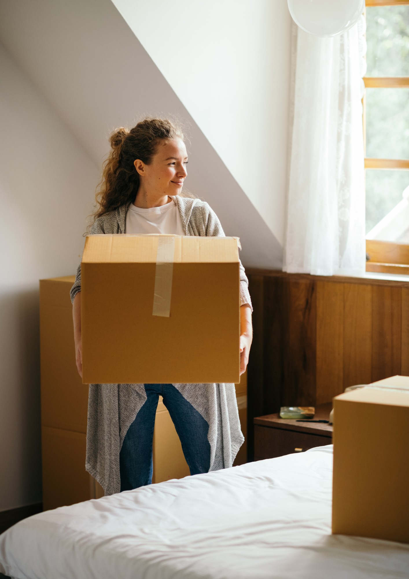 A woman holds a cardboard box
