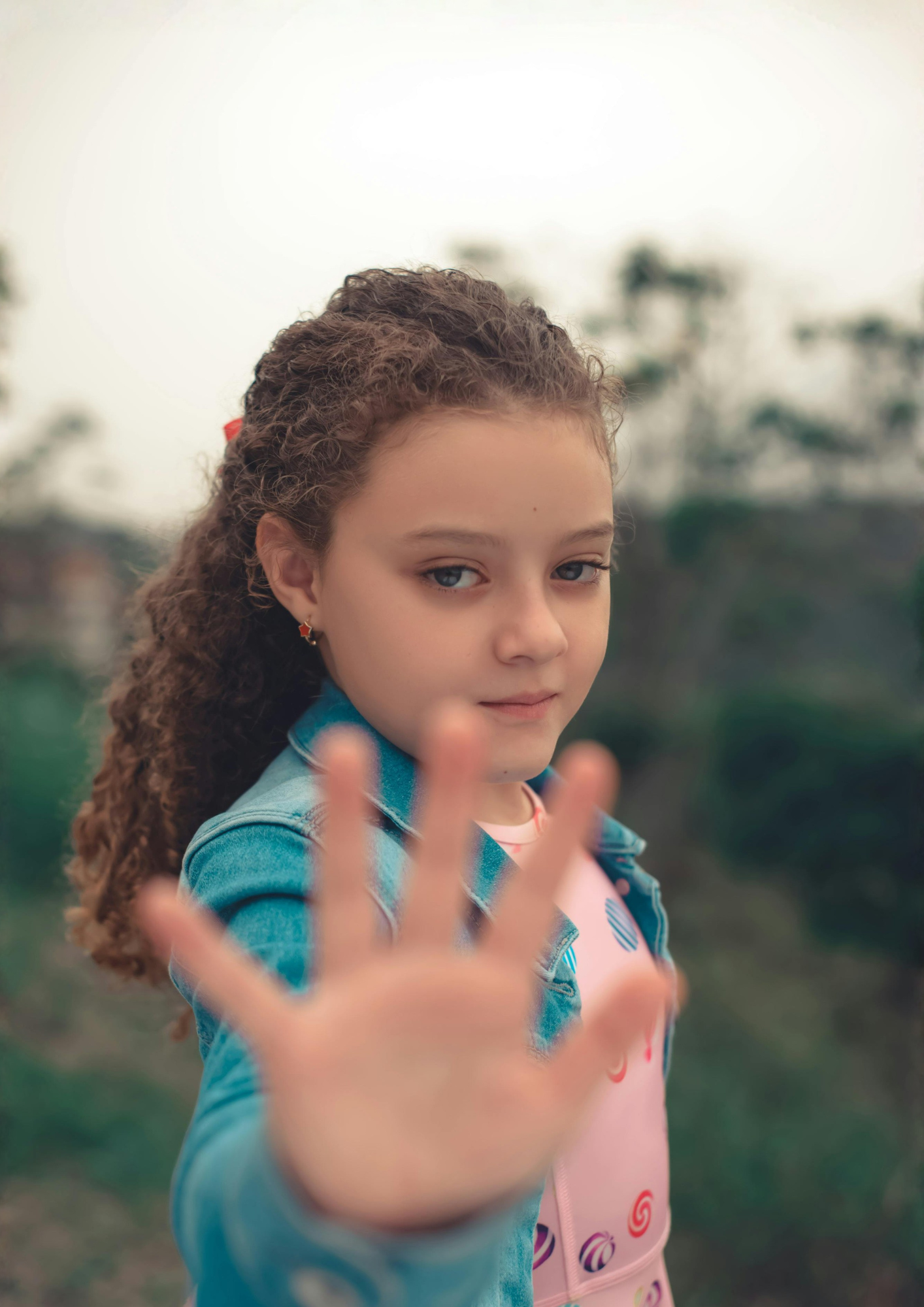 A girl holds out her hand