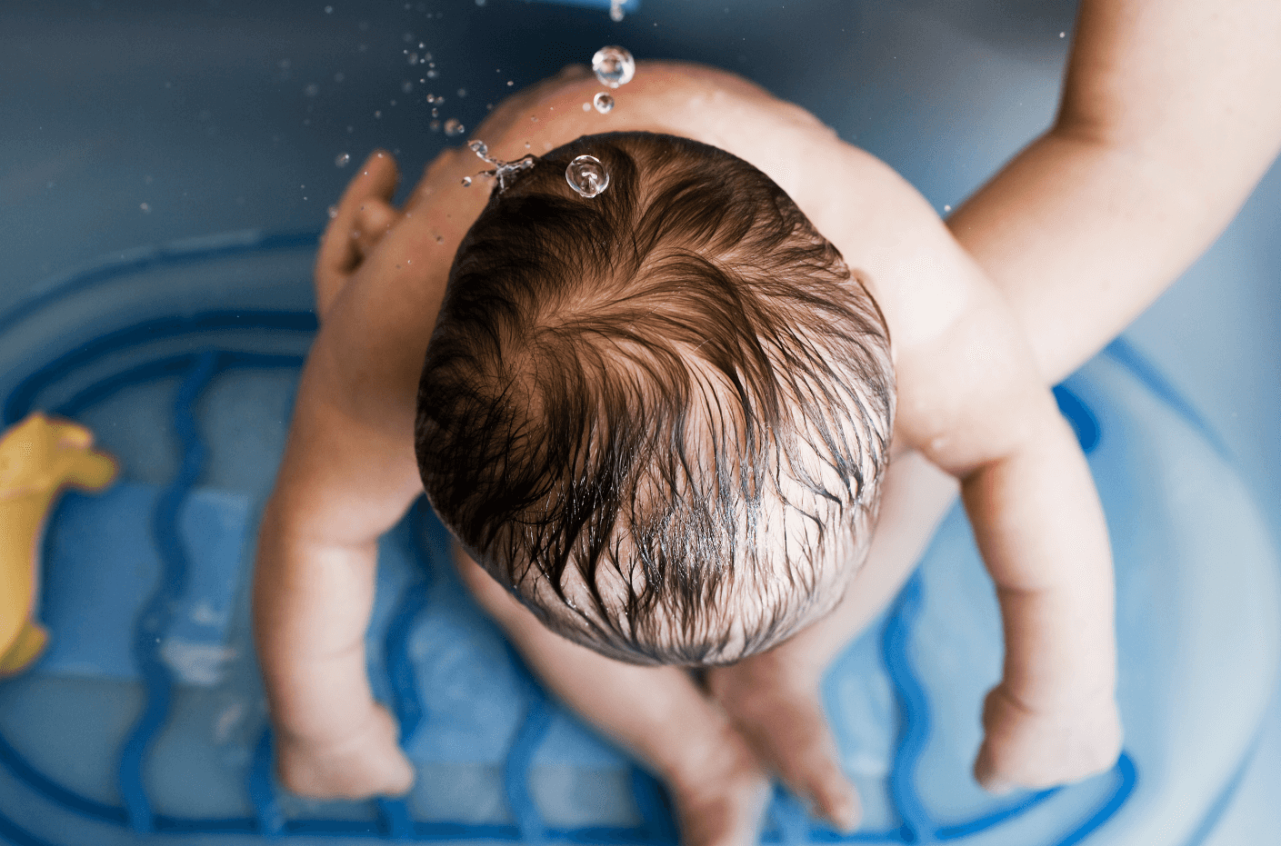 A baby in the bath from a bird's-eye view