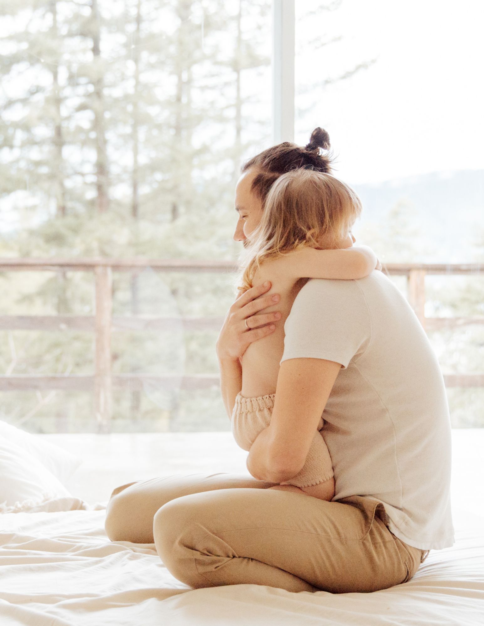 A parent hugging their toddler