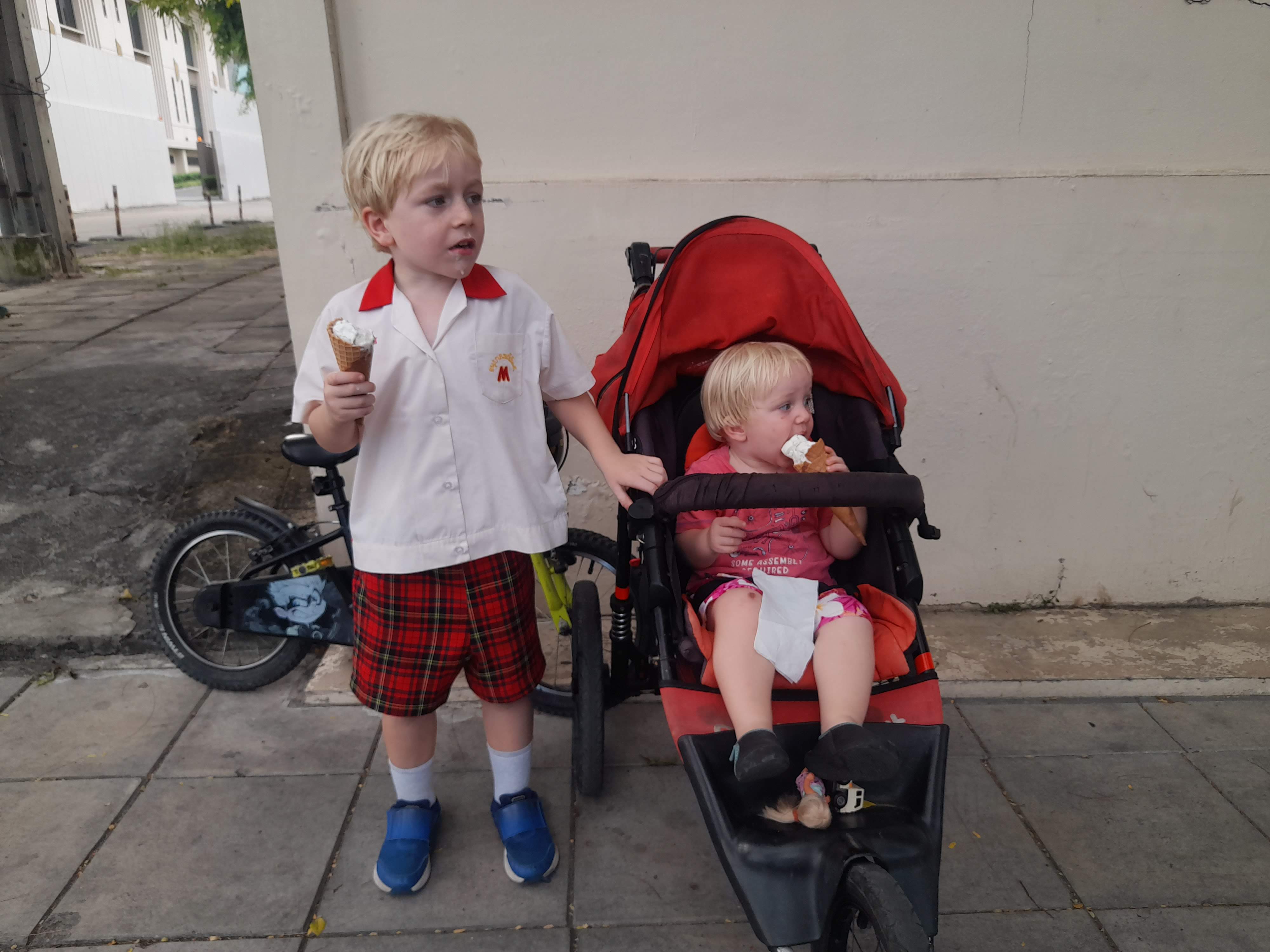 Two children eat ice cream
