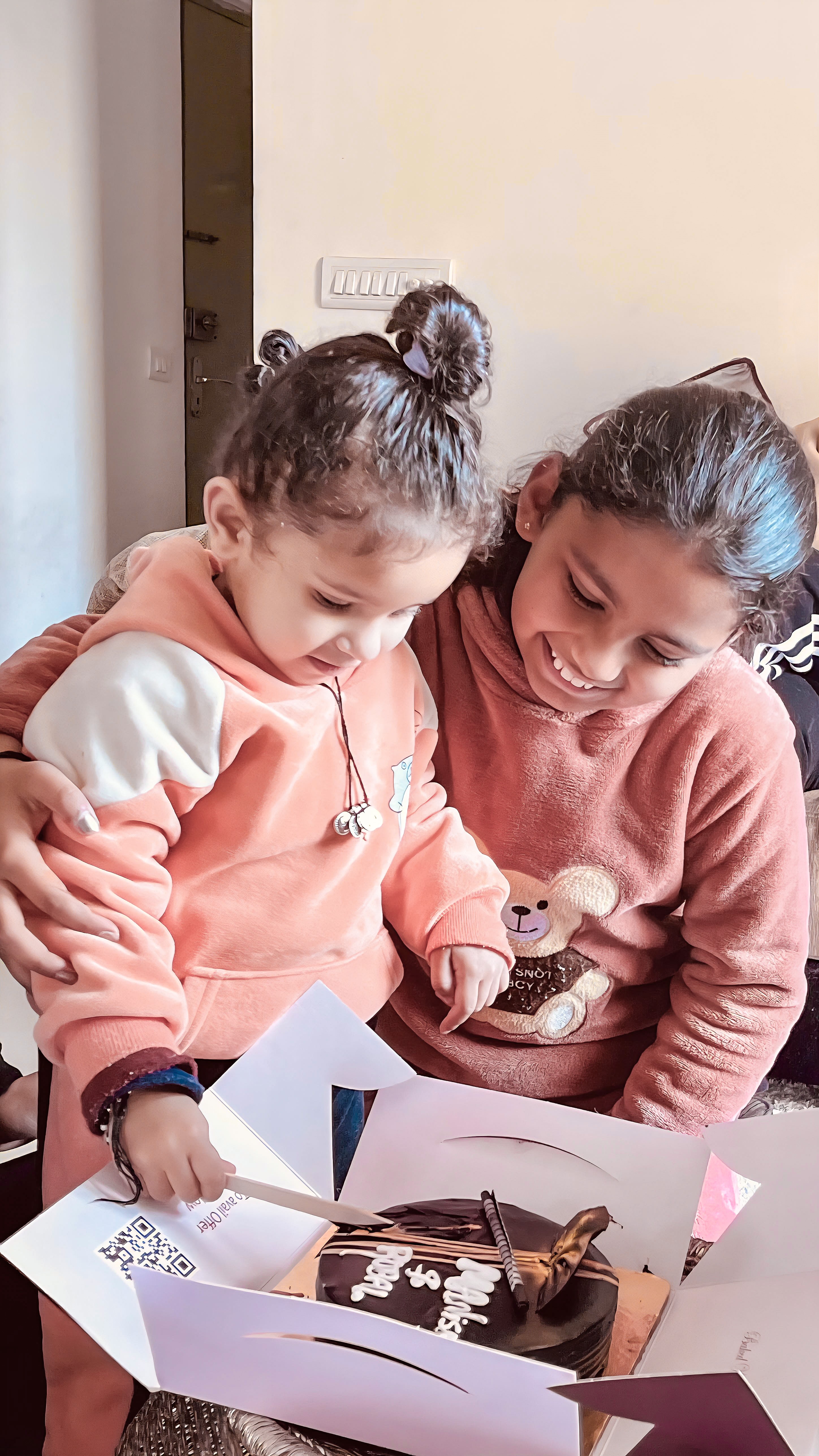 Two girls look at something together