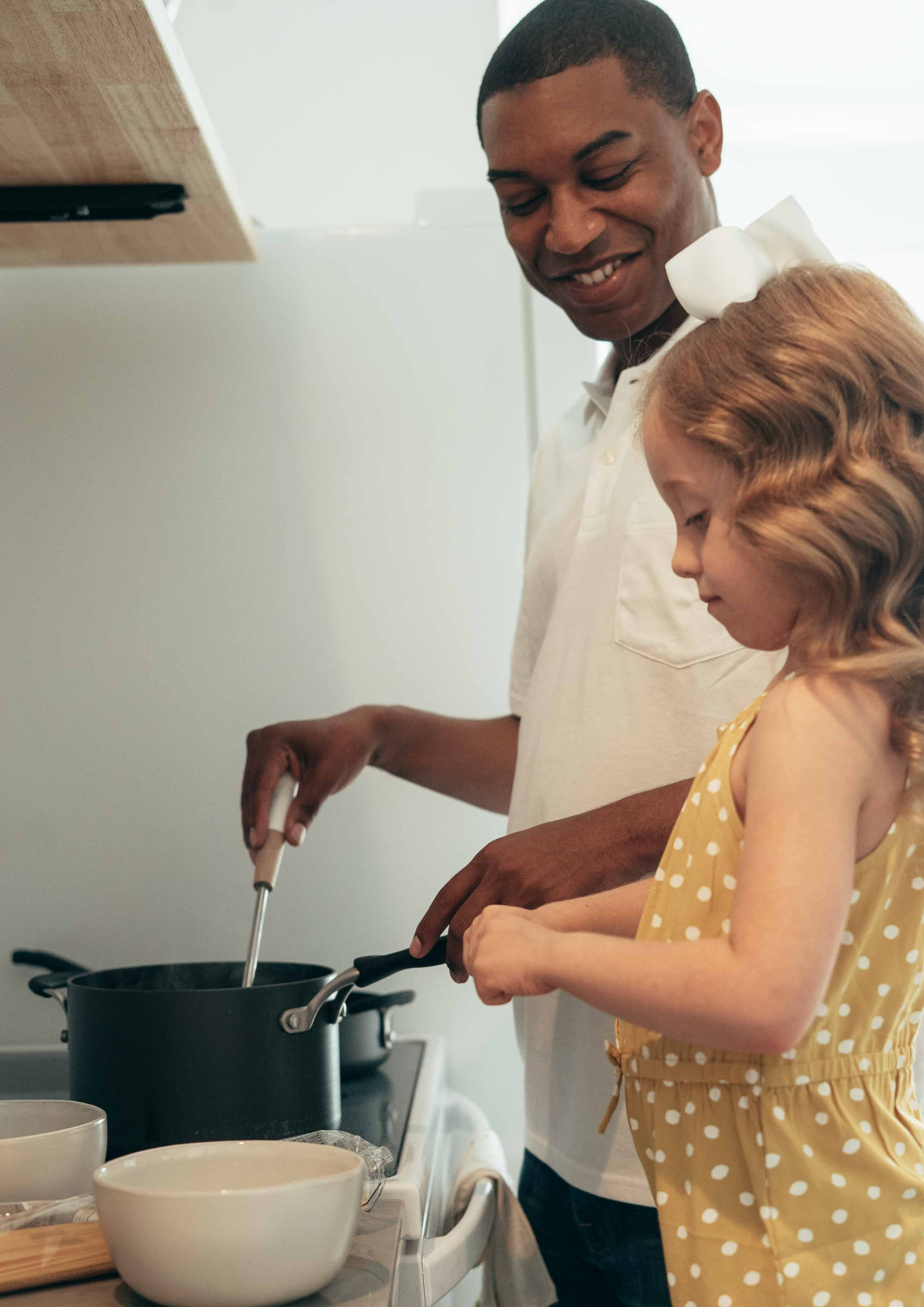 A father and daughter cook together