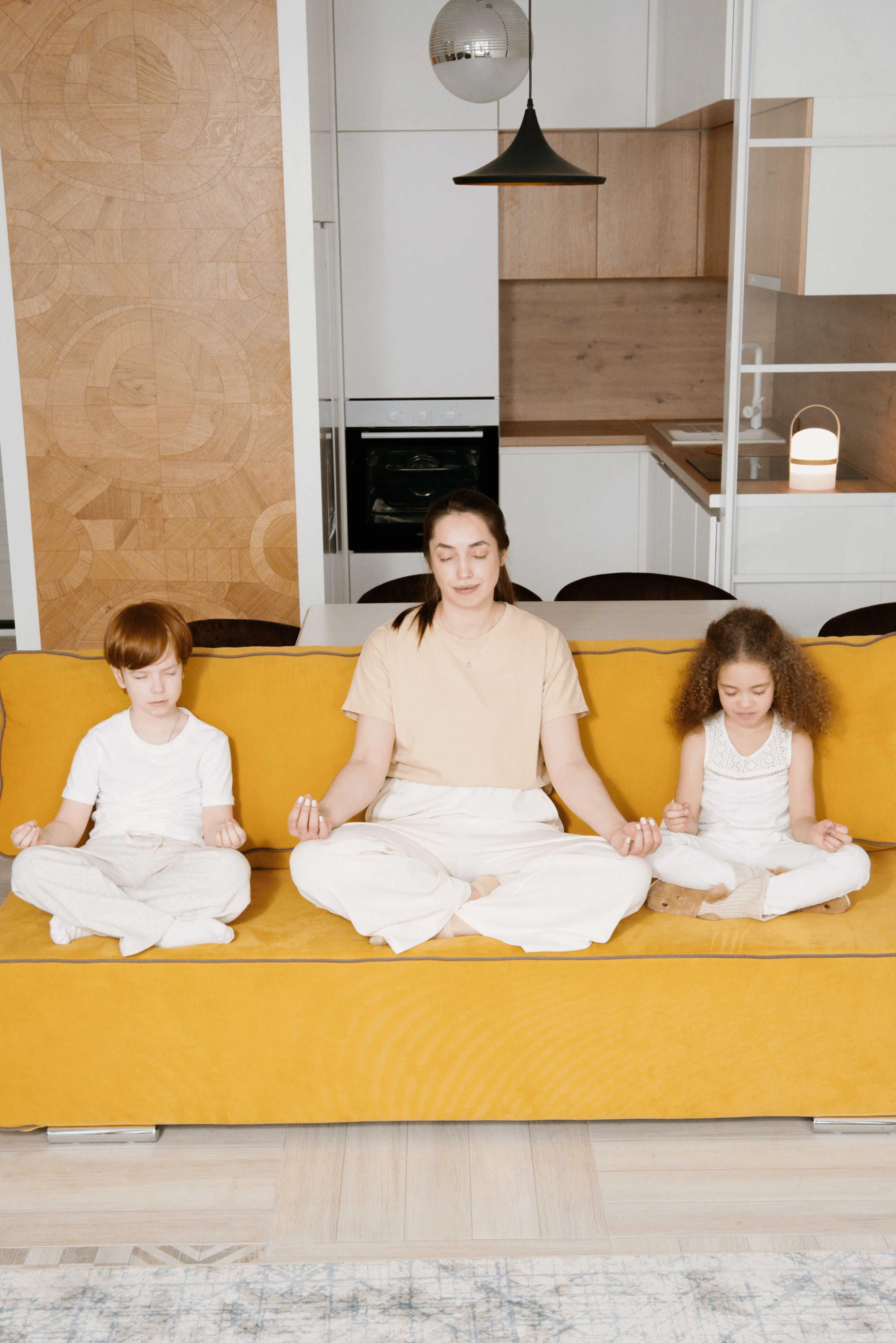 A woman and children doing yoga