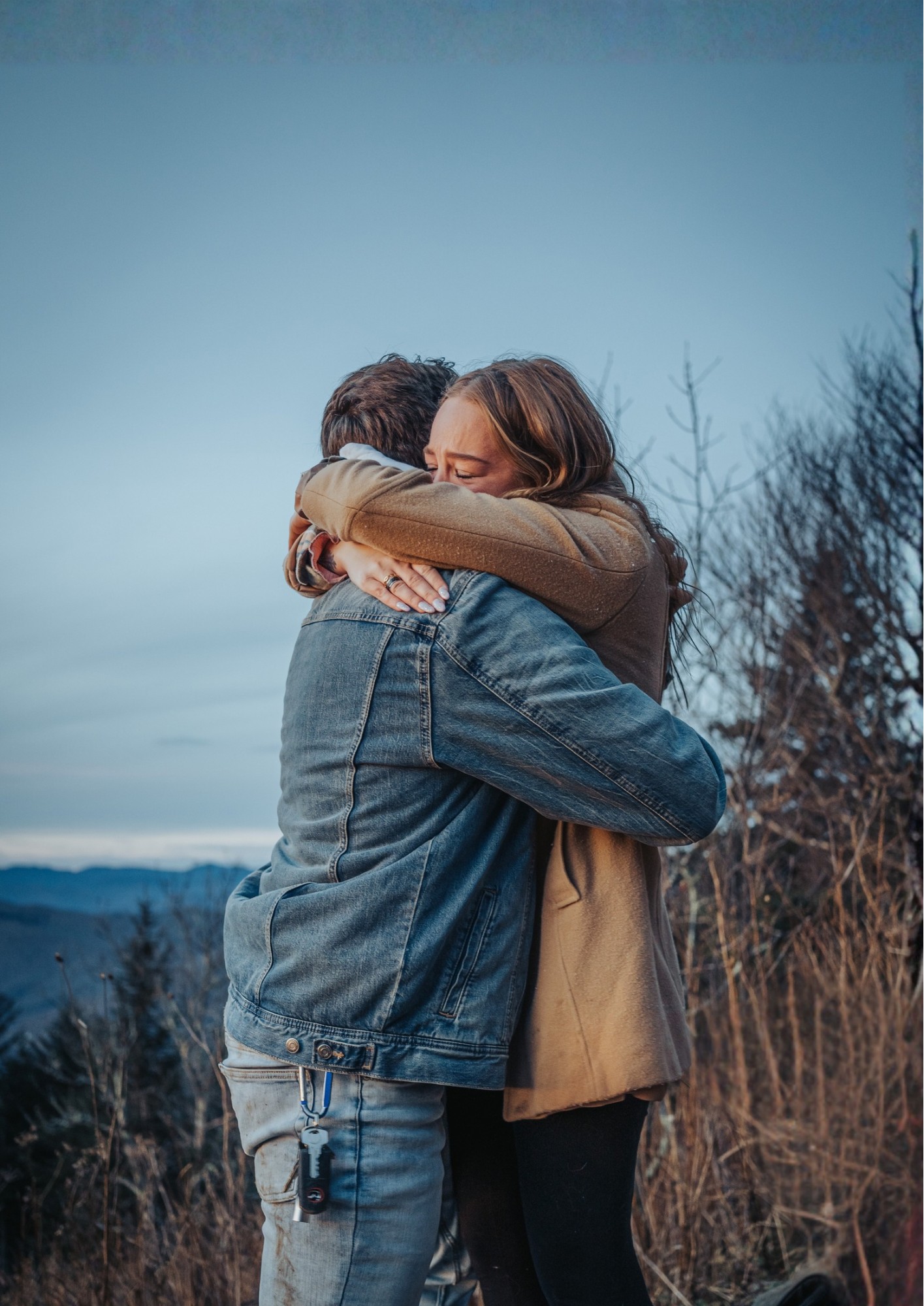 A couple hug outside