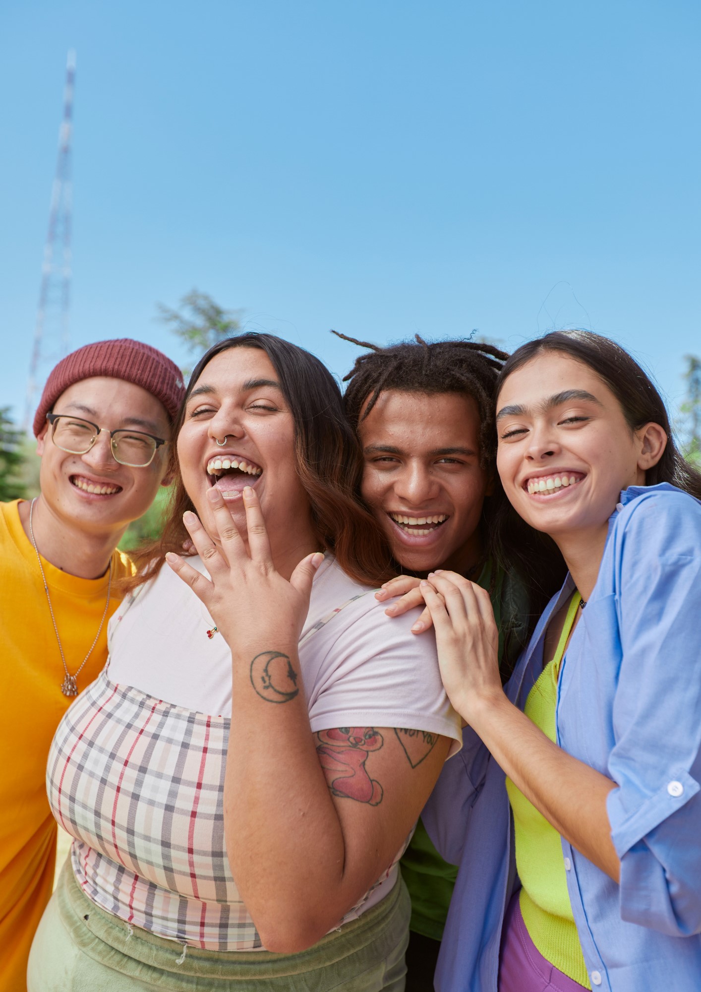 Four friends smile into the camera
