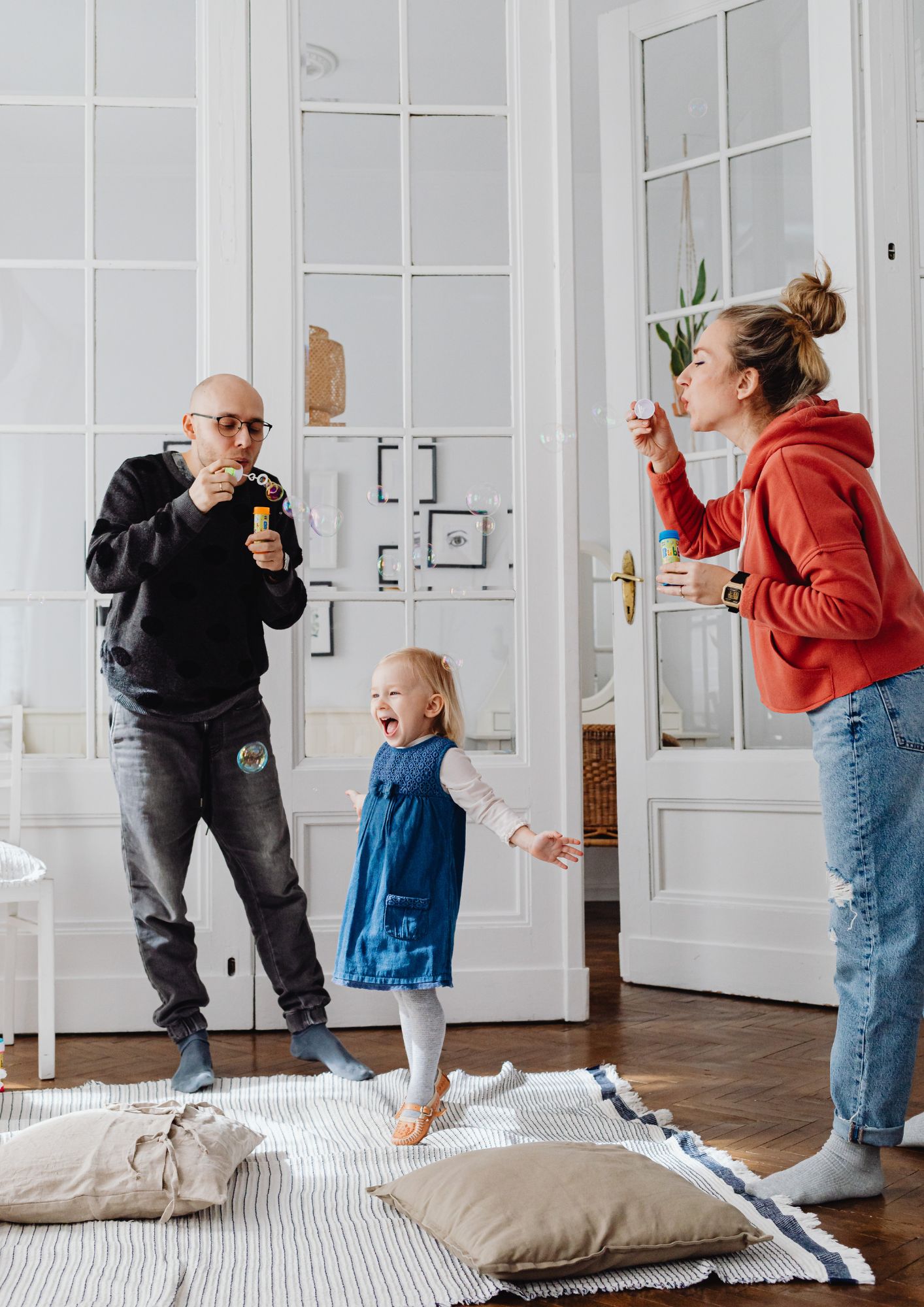 A family blows bubbles indoors