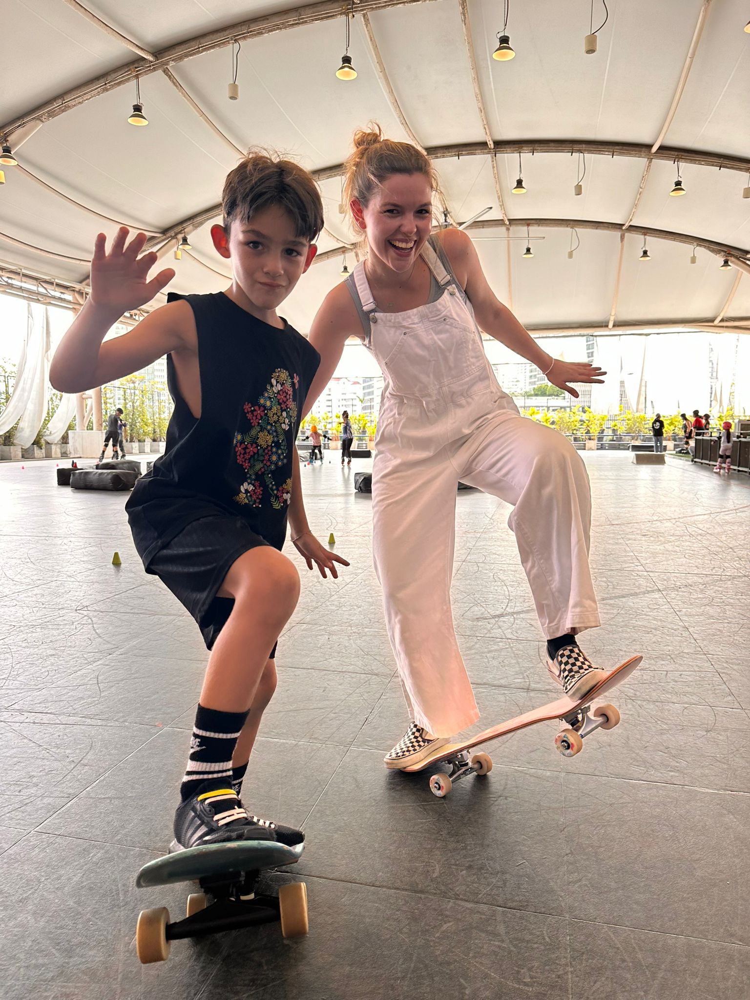Two children enjoy skating at Roller Dome, Bangkok