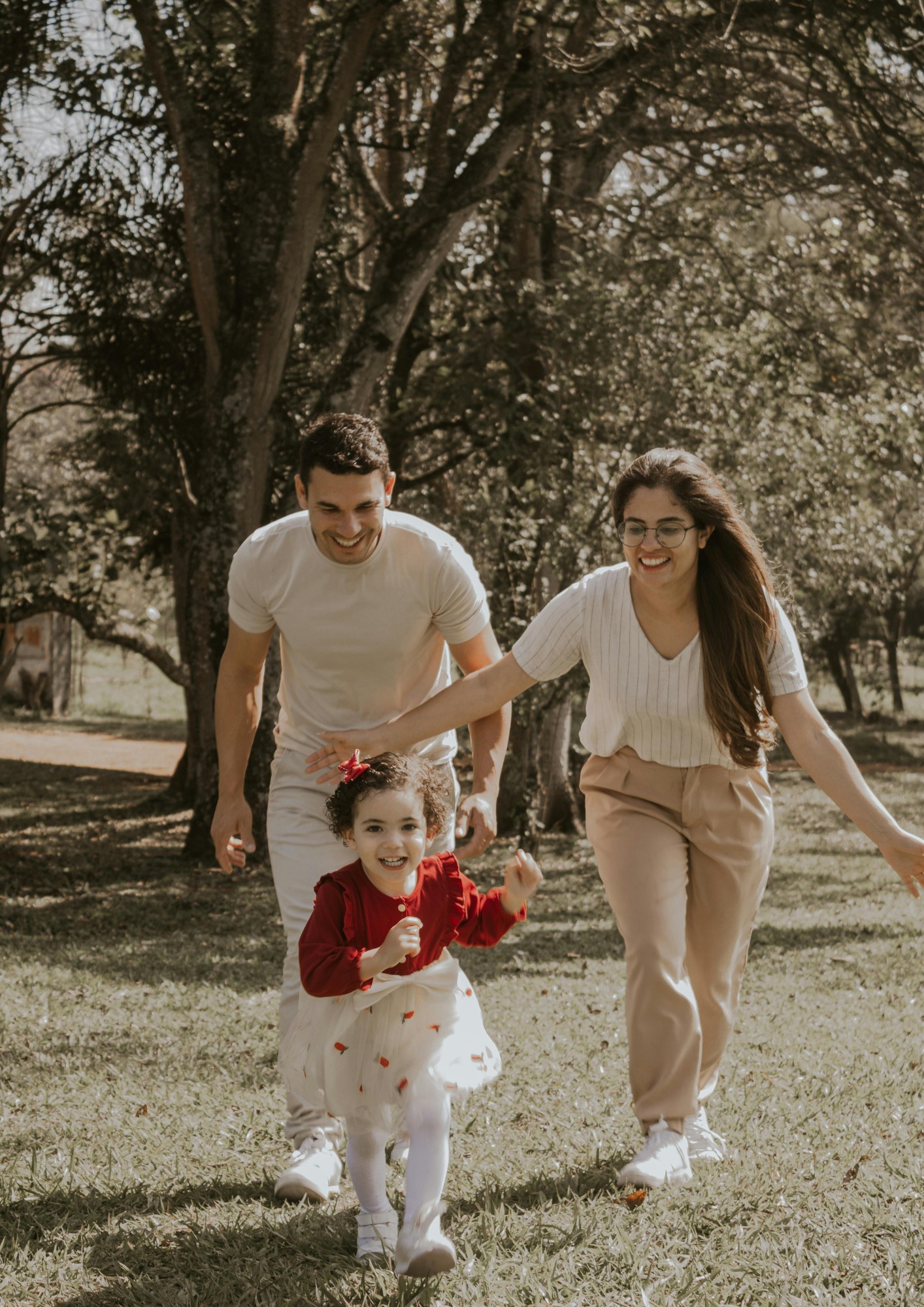 A mother and father walk with their child