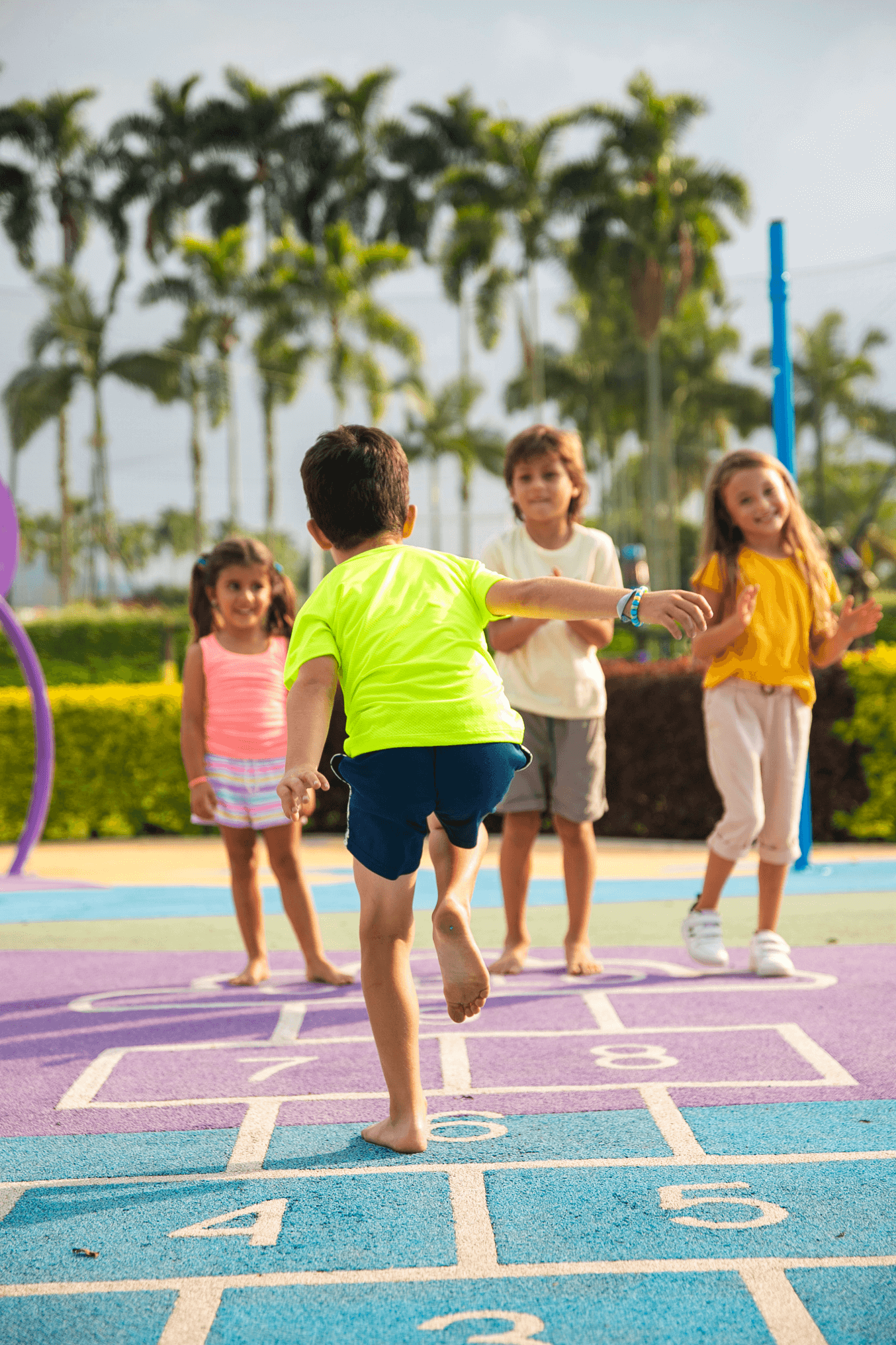 A group of children playing hopscotch