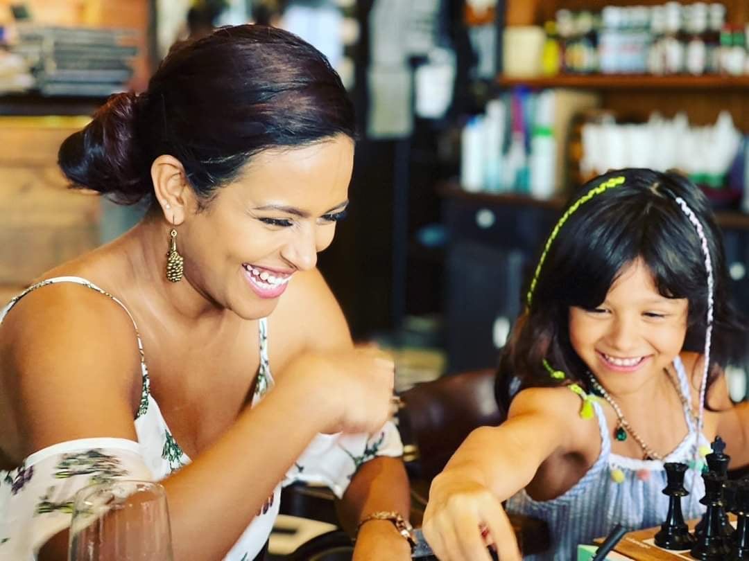 A mother and daughter laughing together