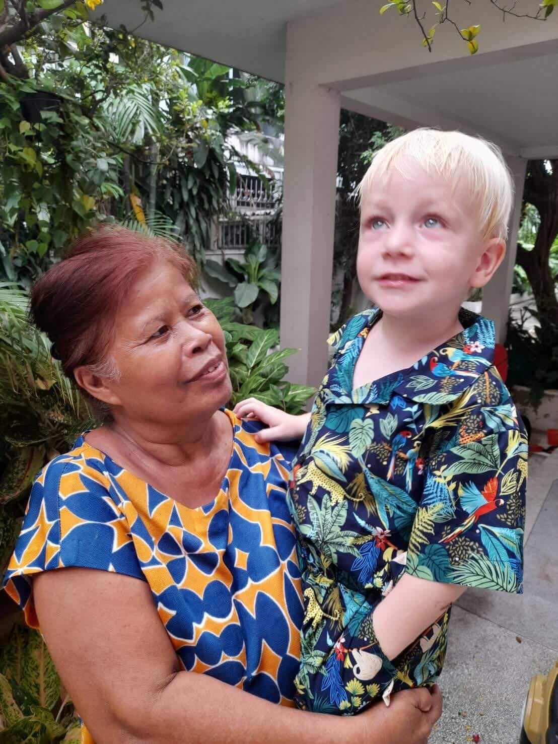 A Thai woman holding a White toddler