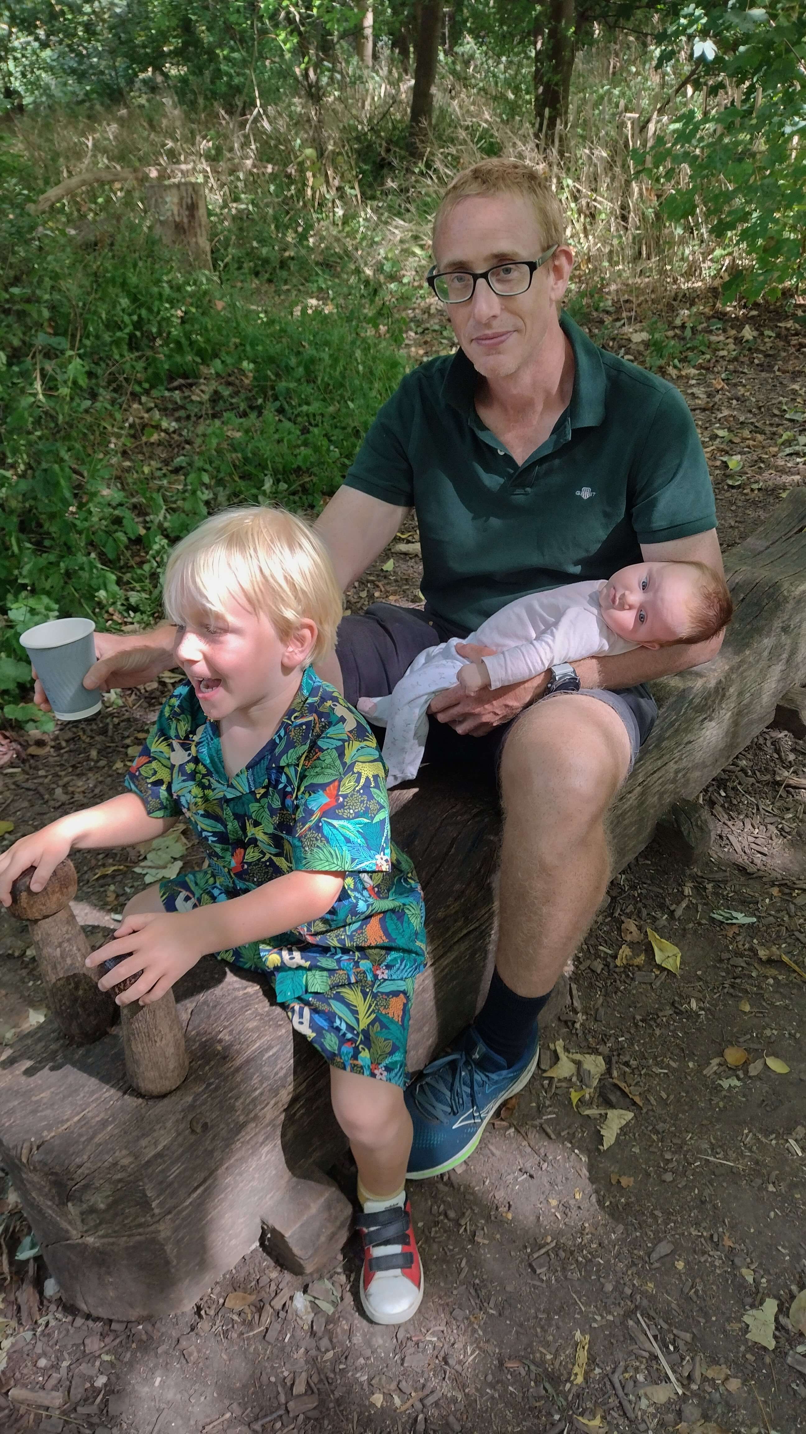 A white dad with his toddler and newborn