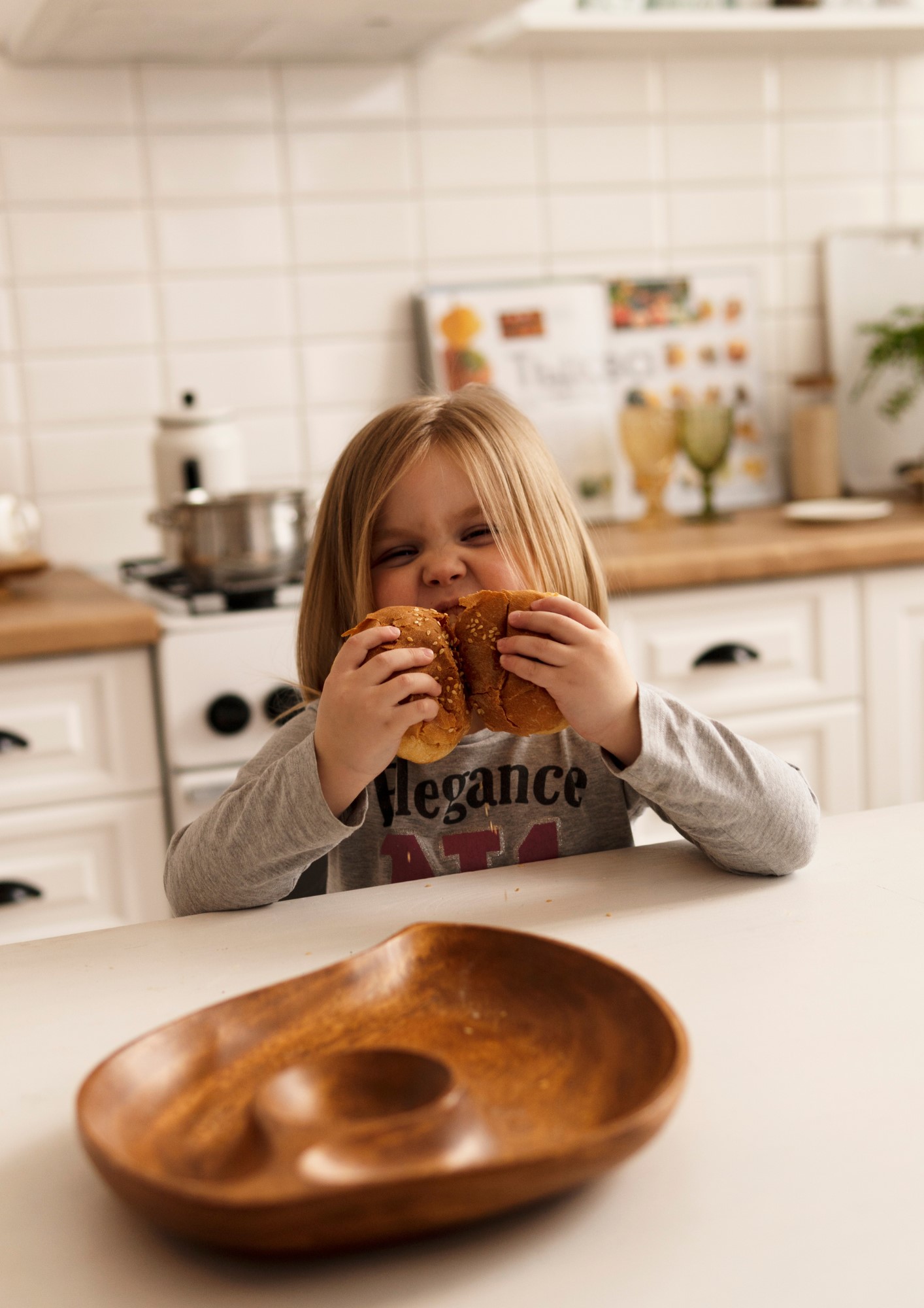 A child tears into a bagel.