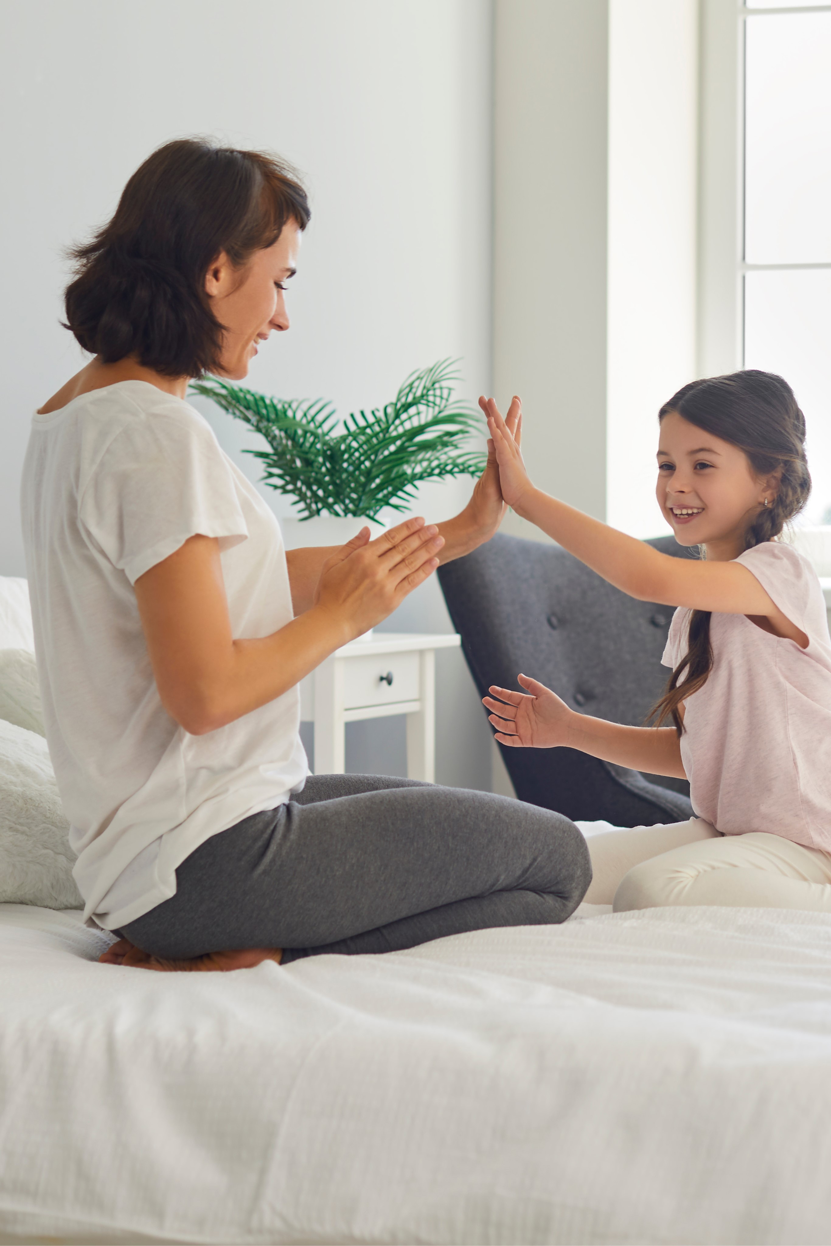 A mother and daughter high-five each other