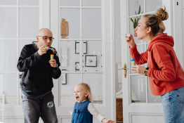 A family blow bubbles indoor