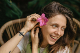 A lady puts a flower in her hair