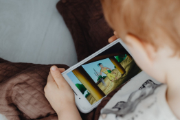 A boy stares at a computer game