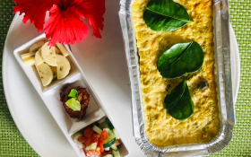 Cooked and ready to serve bobotie beside garnish