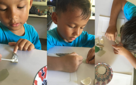 A young Thai boy crafting with natural materials