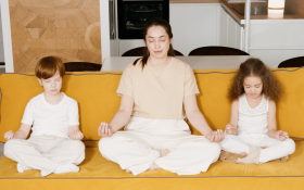 A mother and her two children meditating together