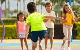 A group of children playing hopscotch