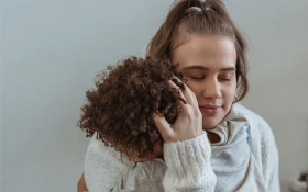 A mother comforting her child during a meltdown