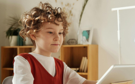 A child stares at a screen.