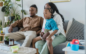 A family play a computer game together