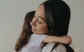 A mother hugs her daughter