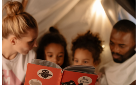 A family read in a tent