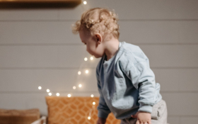 A child jumps on a bed