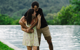A man and water hug on a river bank