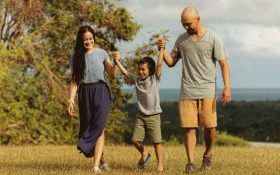 Parents swing a child between them