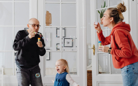 A family blow bubbles indoor