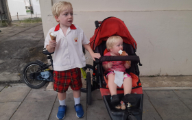 Two children eat ice creams