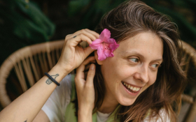 A lady puts a flower in her hair