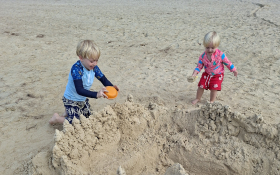 Two children play in the sand