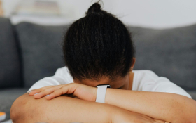 a lady has her head in her hand