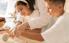 Two kids cook with their mother