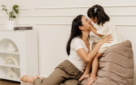 A mother and daughter kiss