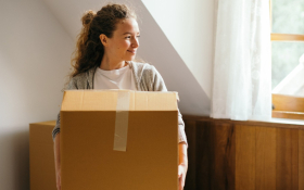 A woman holds a cardboard box