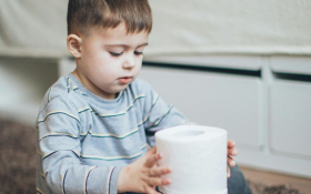 A boy with toilet paper