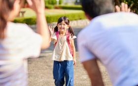 A girl waves goodbye