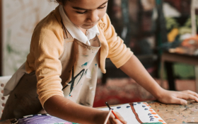  A girl draws with crayons
